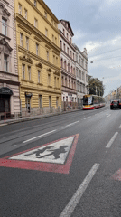 Trams and emergency traffic on a busy Prague street