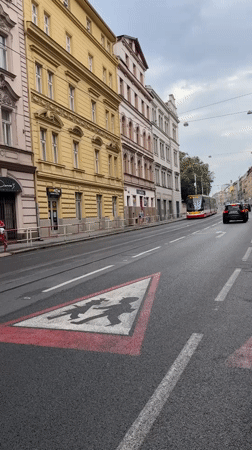 Trams and emergency traffic on a busy Prague street