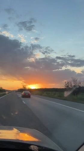 Evening traffic captured on Bulgarian highway during sunset