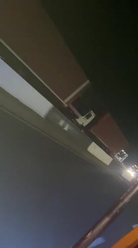 Illuminated truck convoy travels highway near Ado, Nigeria