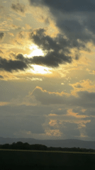 Sunset captured through clouds over Bulgarian countryside field