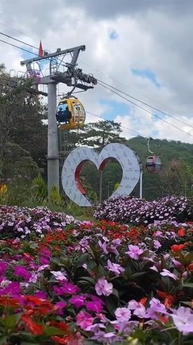 Tourist plays on decorative bicycle at Da Lat garden attraction