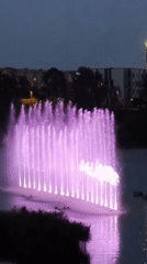 Color-shifting fountain lights up a Tallinn waterway at dusk