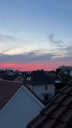 Rooftop barbecue in Viernheim under a vivid summer sunset