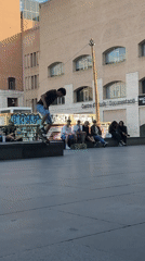 Skaters gather in Barcelona plaza on sunny afternoon