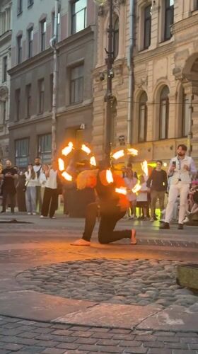 Fire spinners and street performers work the cobblestones of Saint Petersburg