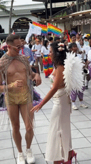 Pride parade in full swing: costumes, dancers, and rainbow flags