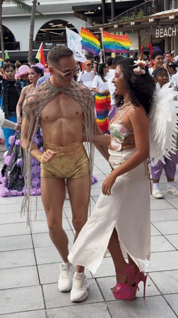 Pride parade in full swing: costumes, dancers, and rainbow flags