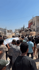 Funeral procession carries shrouded body through damaged Gaza streets