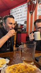 Men share drinks and food at Chaikovsky pub