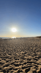 Late afternoon sun over a busy Punta Umbría beach
