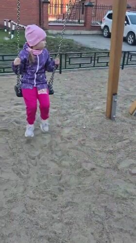 Children play at Tobolsk park playground with swings, scooters