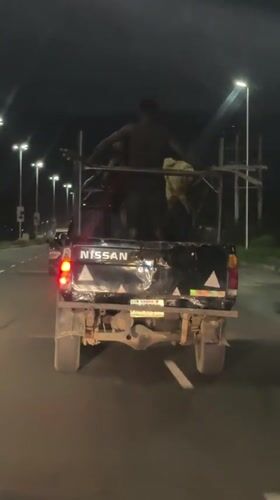 Passengers ride in modified pickup truck bed in Nigeria
