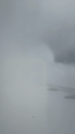 Passenger documents European flight with aerial views, entertainment display