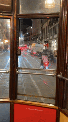Milan tram passenger documents evening journey, door closure