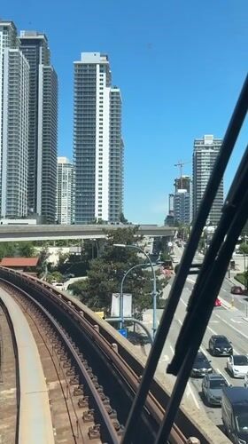 Train journey through Burnaby-Coquitlam corridor on sunny afternoon