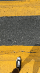 Pedestrian crosses yellow crosswalk near In-N-Out in Los Angeles