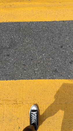 Pedestrian crosses yellow crosswalk near In-N-Out in Los Angeles