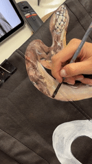 Artist paints snake design in Krasnoyarsk craft session
