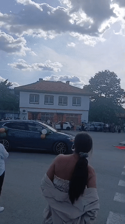Community gathering with decorated vehicle in Bulgarian village
