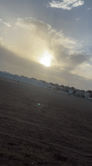 Overcast evening scene captured over dirt field in Safi