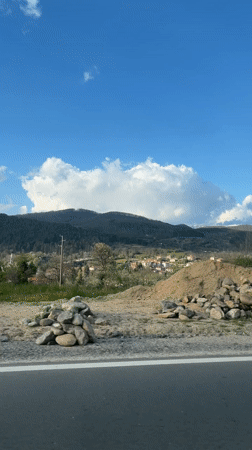 Traveler captures sunny mountain scenery from road in Bulgaria
