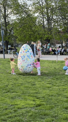 Toddlers play near decorated Easter egg in Sofia park