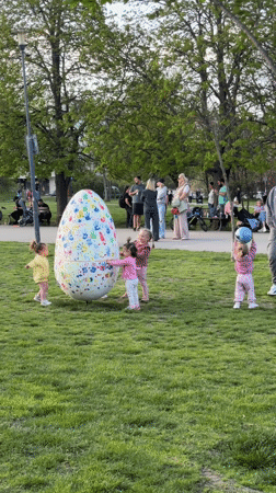 Toddlers play near decorated Easter egg in Sofia park