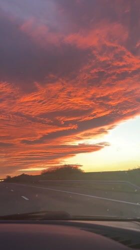 Dramatic sunset illuminates Zheleznik sky in orange and red