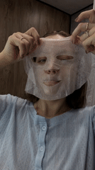 Woman performs morning skincare routine in Reshetnikovo, Russia