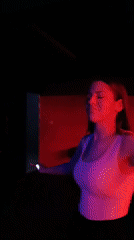 Young women gathered in neon-lit dark environment