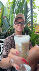 Woman enjoys late night coffee outdoors in snake-print shirt