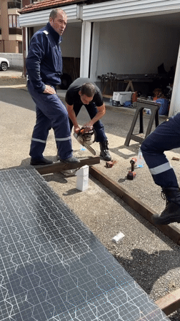 Workers cut wooden beam with chainsaw in Kazanlak
