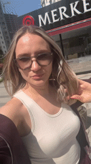 Woman films selfie near decorated storefront in Esenyurt