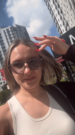 Woman films selfie near decorated storefront in Esenyurt