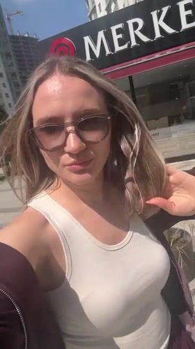 Woman films selfie near decorated storefront in Esenyurt