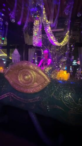 Nightclub event with DJ and purple-lit beachside area in Thailand