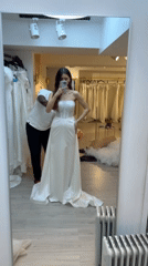 Woman tries on wedding dresses at Paris bridal shop