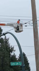 Utility worker performs overhead line maintenance in Coquitlam