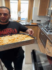Man prepares homemade pasta dish in Aprilia kitchen