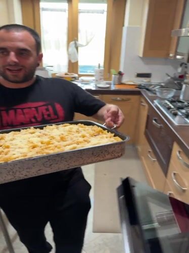 Man prepares homemade pasta dish in Aprilia kitchen