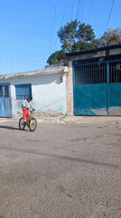 Cyclist performs wheelies on residential street in Porlamar, Venezuela