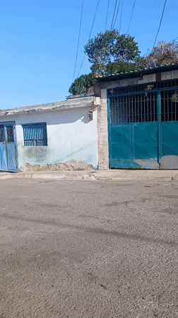 Cyclist performs wheelies on residential street in Porlamar, Venezuela