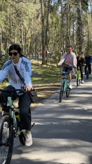 Four cyclists ride through wooded path in Zelenogorsk