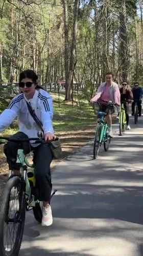 Four cyclists ride through wooded path in Zelenogorsk