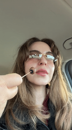 Woman eating lollipop in car captured in Moscow