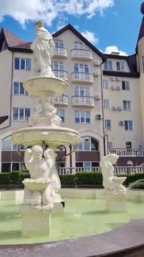 Classical white fountain outside a building in Skhidnytsia, Ukraine