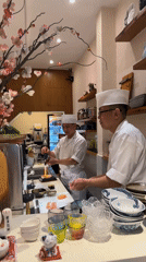 Sushi chefs prepare torched salmon at Thủ Đức restaurant
