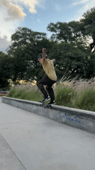 Blue-haired skater performs tricks at Buenos Aires skate park