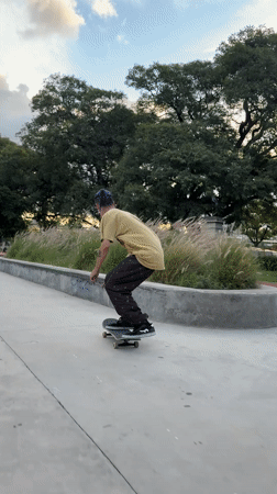 Blue-haired skater performs tricks at Buenos Aires skate park
